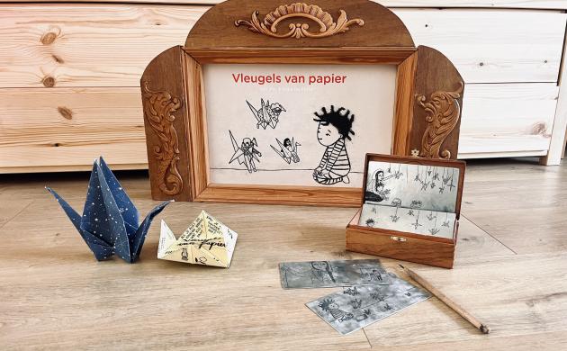 Materiaal om te tekenen en een origami vogel